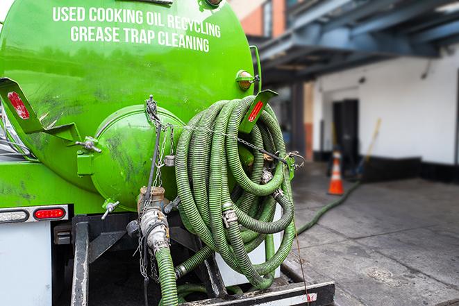 a pump truck emptying a grease trap in Costa Mesa